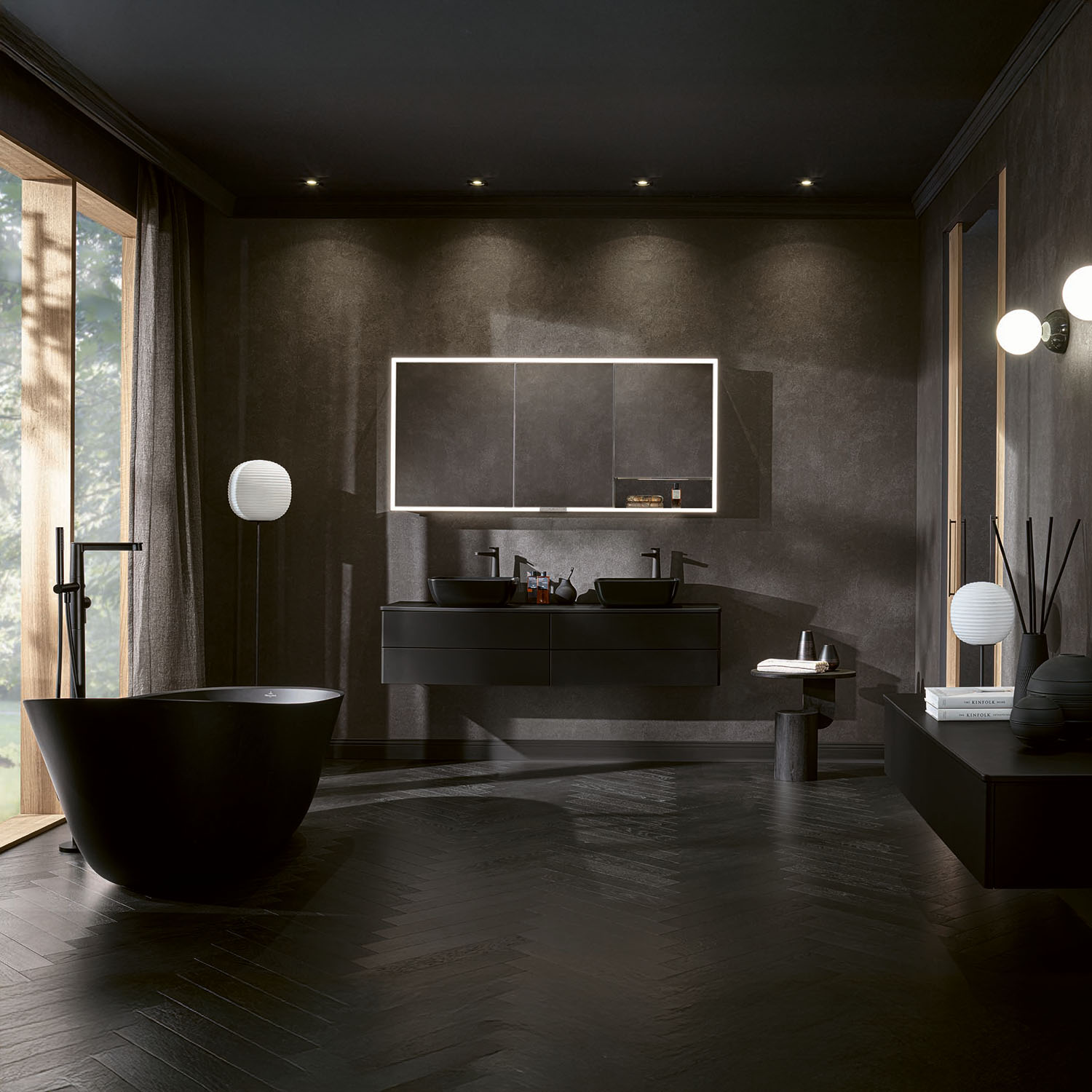 Black freestanding bath in a dark contemporary bathroom